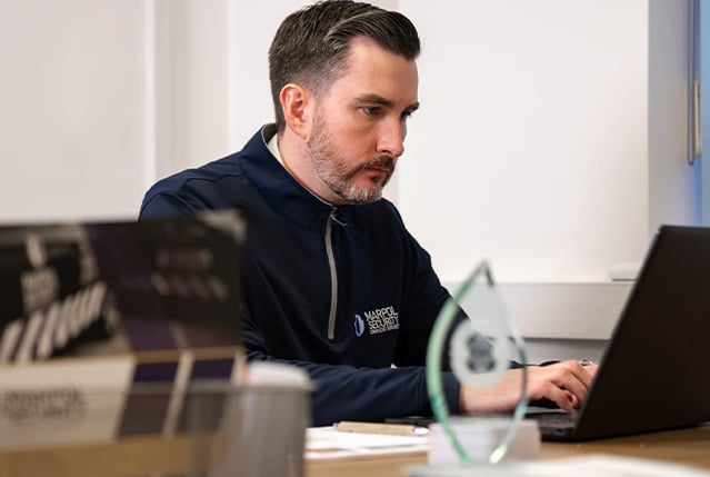 A Marpol staff member working on a laptop