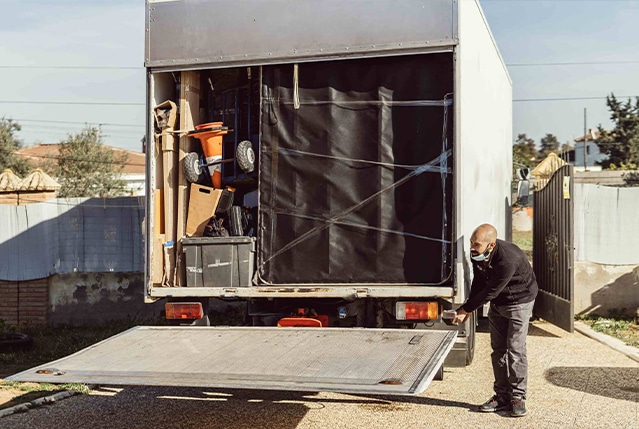 A worker loading a van