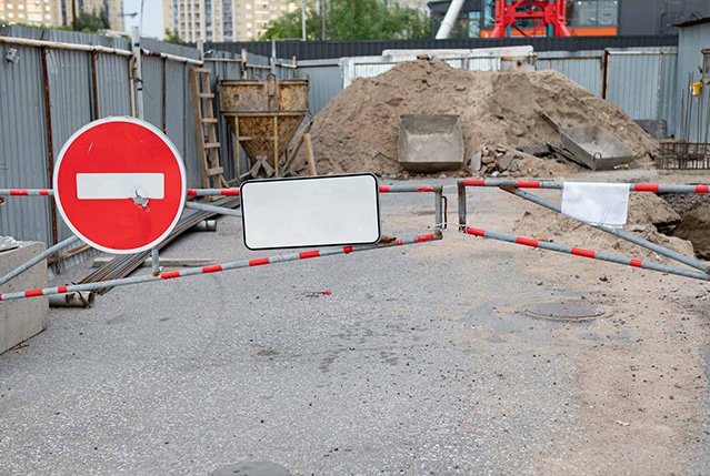 A temporary gate blocking entrance to a construction site